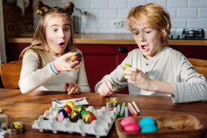 kids making easter eggs
